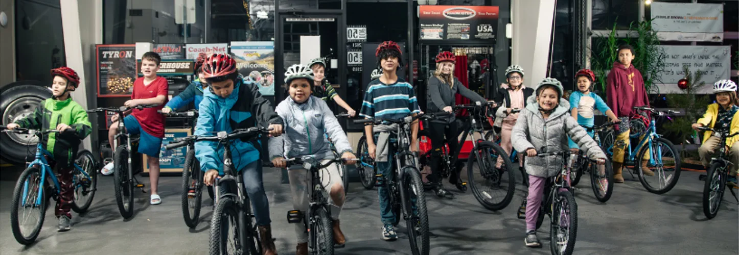 Children receiving donated bicycles